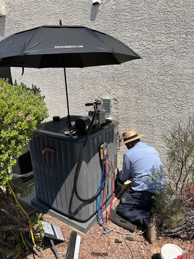 HVAC technician performing outdoor AC maintenance in Frostburg